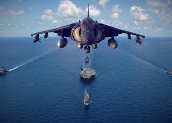 Fighter jet over aircraft carrier