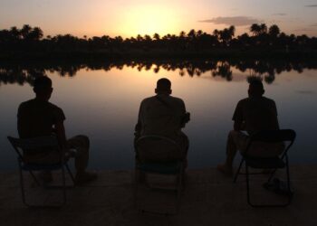 Three men on a lake
